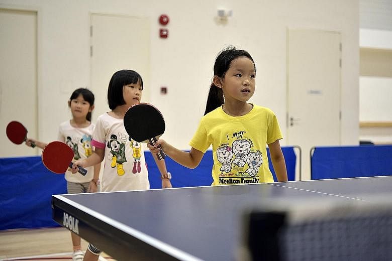 Top: Children at the Wang Yuegu Table Tennis Academy learning the proper way to grip a bat. Above: The 38-lane bowling alley at Temasek Club is where the national team train.