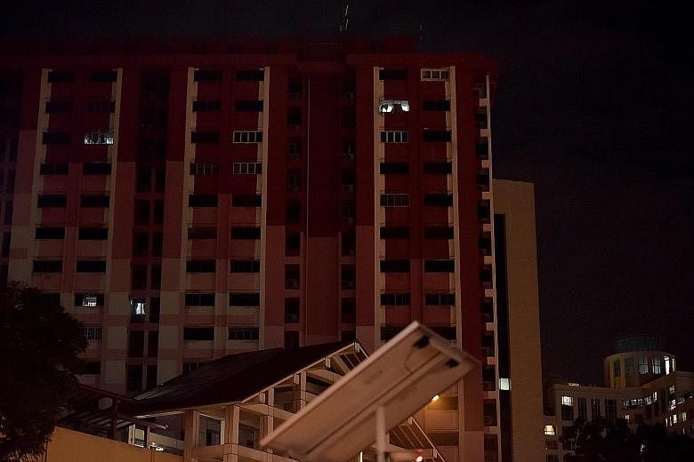 Above: Only a few units were lit at Rochor Centre last Thursday. Right: Bryanna and her sister Gianna, two, will be moving out with their family next month.