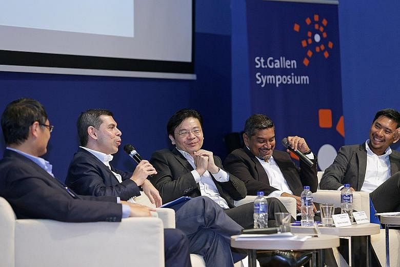 On the panel at the symposium yesterday were (from left): Dr Tan Chi Chiu, Mr Warren Fernandez, Mr Lawrence Wong, moderator Viswa Sadasivan, who is chief executive of Strategic Moves and a former Nominated MP, and Mr Martin Tan.