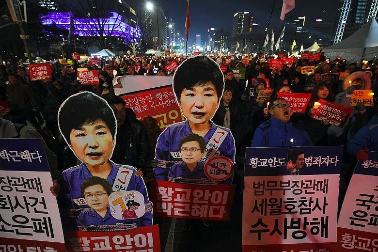 Protesters demanding the immediate resignation of President Park in Seoul last Saturday. As the Constitutional Court looks into whether to impeach Ms Park, her proposal over the presidency is ironically being debated.