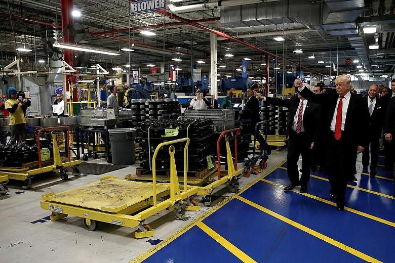 Mr Trump visiting a factory in Indiana on Dec 1. His campaign maintained that manufacturing jobs were lost overseas, but experts say automation is another factor and new plants are unlikely to bring jobs back.