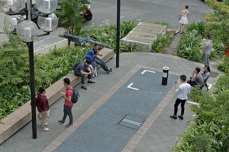 This smoking zone outside Far East Plaza adds to others already designated at shopping malls and office buildings. The Orchard Road Business Association has pushed for smoking points to be sited in back lanes.