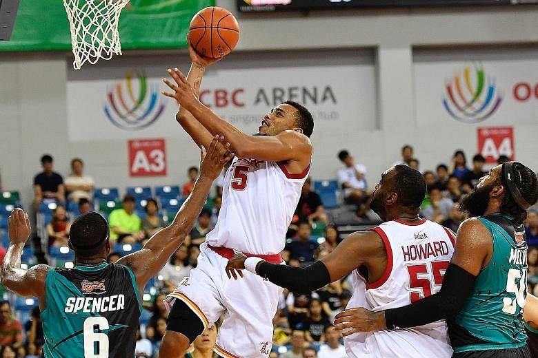 Singapore Slingers' Xavier Alexander attempts to score against the Malaysia Dragons in a thrilling Asean Basketball League (ABL) game at the OCBC Arena yesterday. In a nail-biting game, which went into double overtime, the hosts clawed back from 72-7