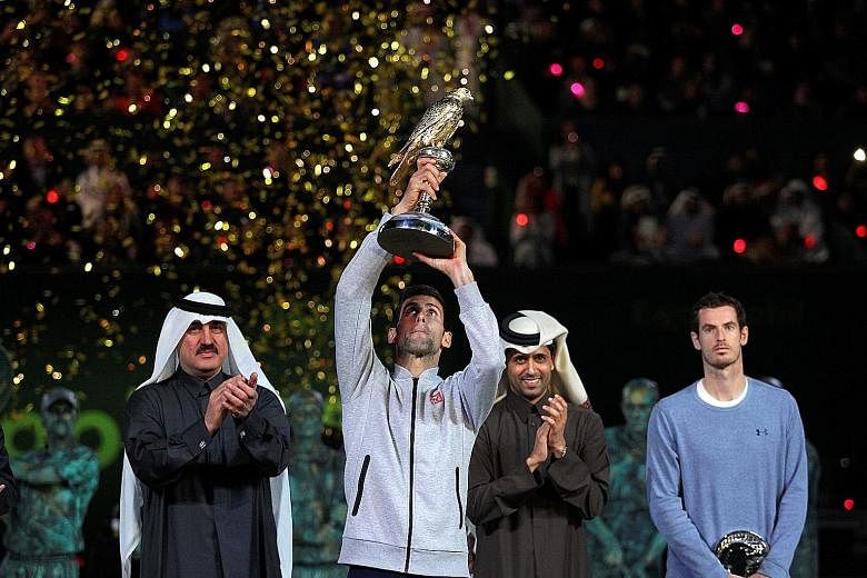 Novak Djokovic lifts the Qatar Open trophy after defeating world No. 1 Andy Murray 6-3, 5-7, 6-4. The Serb has never lost to Murray after winning the opening set.