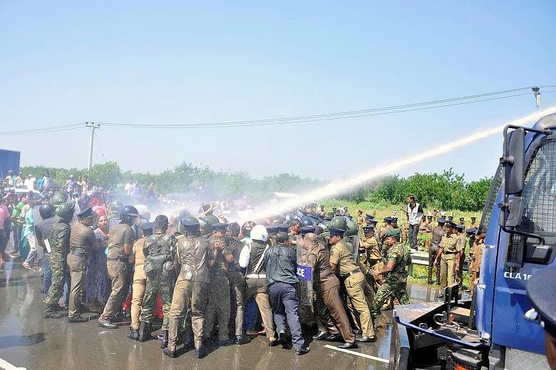 Police clashing with protesters who claim thousands of families will be evicted to provide land for a planned industrial zone for Chinese investors, in Hambantota, Sri Lanka, on Saturday.