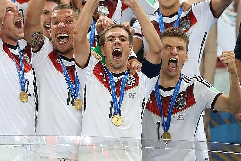 Germany captain Philipp Lahm raising the World Cup trophy after they beat Argentina in the 32-team 2014 World Cup Finals.