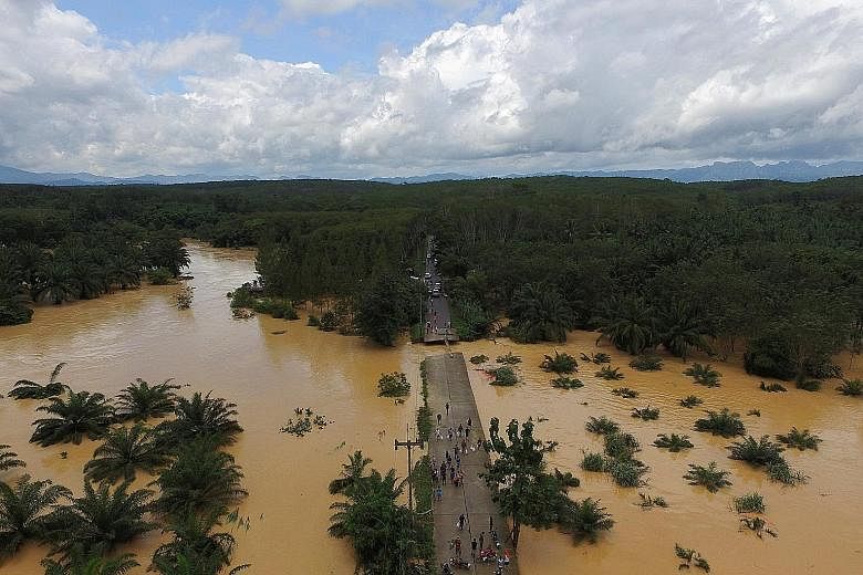 A bridge damaged by floods in Chai Buri District in Surat Thani province. The main road heading down Thailand's southern neck was closed after two bridges collapsed in Prachuab Kiri Khan province.