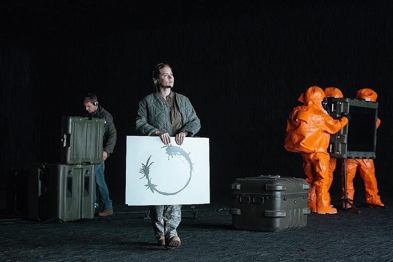 In Arrival, Amy Adams figures out that the aliens communicate using a written language of complex swirls and circular symbols known as logograms.