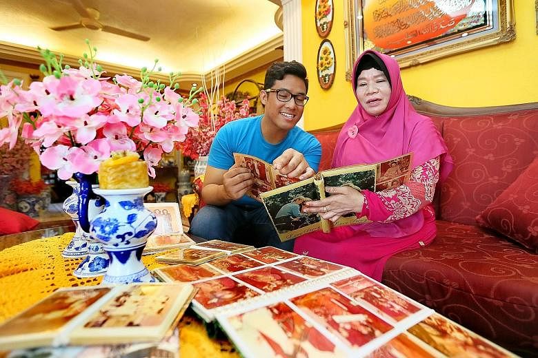 Mr Hafiz Rashid has been learning the language on his own to rediscover his Baweanese roots. He has attended classes and watches YouTube videos (below) of Baweanese songs. Madam Romnah Salleh and her son, Mr Khairul Basysyar Amran, going through phot