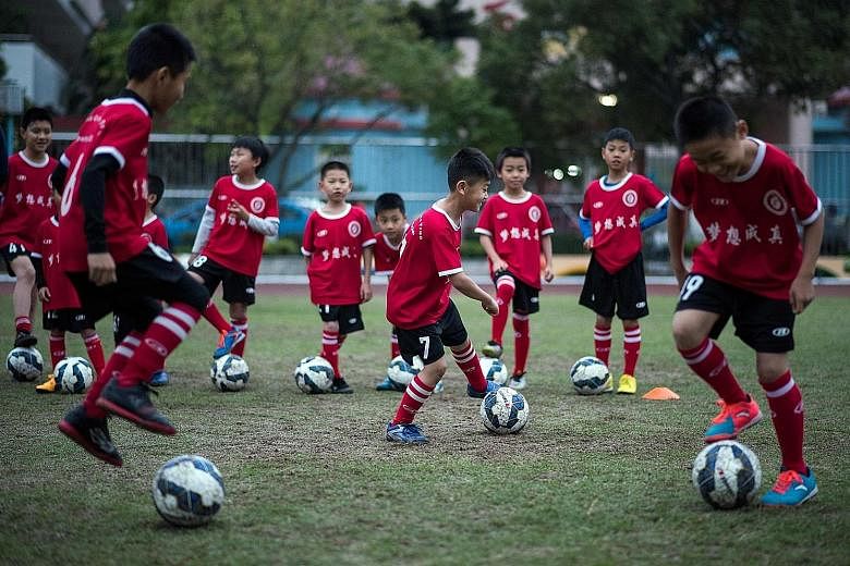 Children training in Guangzhou. China is hoping to produce a generation of top footballers by building thousands of academies.