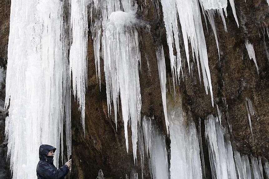 Meterologists forecast wind, rain and snow in 22 provinces in northern Spain, where this waterfall in Roncal, near the French border, has turned into icicles. 
