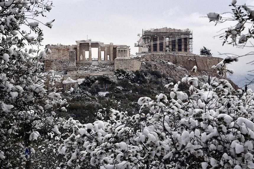 The Acropolis on Tuesday after a rare heavy snowfall in Athens. Some refugees in Greece have been moved to heated tents.
