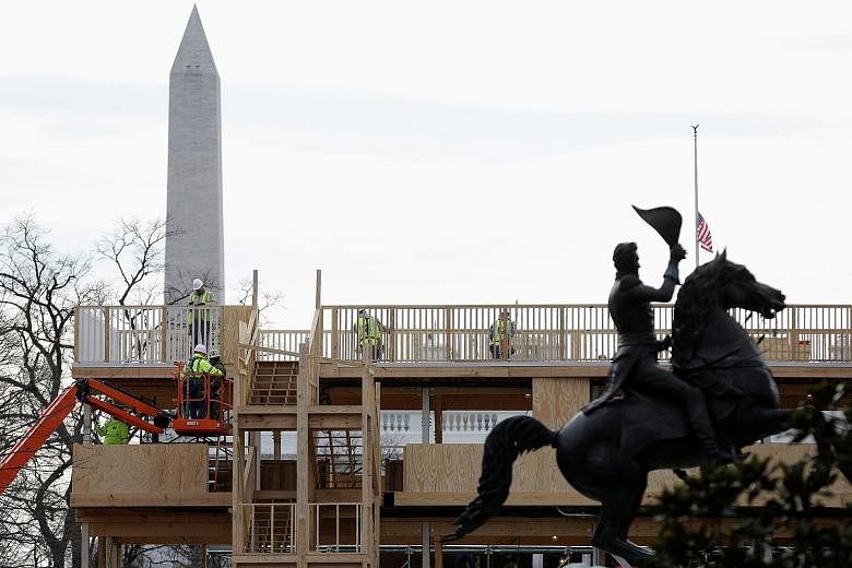 Workers building a reviewing stand for the upcoming presidential inauguration near the White House yesterday. The Trump team has struggled to attract A-list entertainers to flesh out the Jan 20 event, but said the event would have "poetic cadence" ra