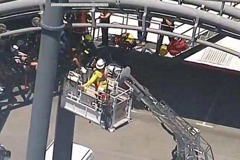 Rescue workers evacuating passengers trapped in their seats 20m off the ground, some for 90 minutes, when the Arkham Asylum ride at Movie World malfunctioned. None of the passengers, mostly teenagers, needed medical treatment. The theme park said the