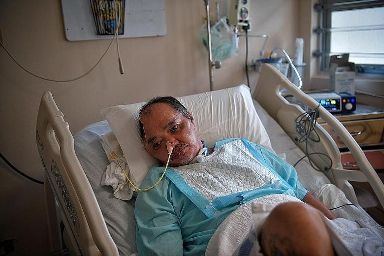 Retiree Lim Chwee Leong in his bed at Tan Tock Seng Hospital. After his accident last November, Mr Lim underwent a tracheostomy and two operations to his brain. Although he has not fully recovered, he told his girlfriend that he could remember his fa