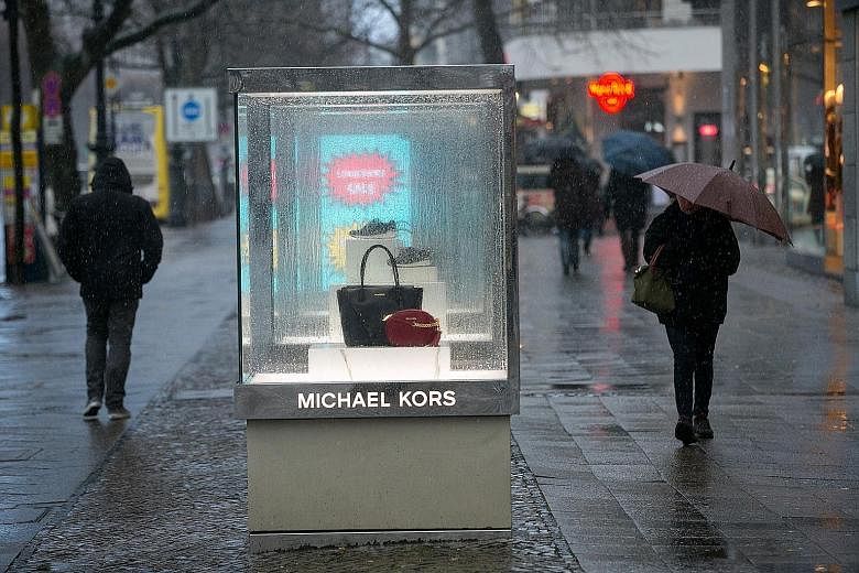 Michael Kors handbags in a display case in Berlin, Germany. The number of new handbag styles the brand introduced In the final three months of last year dropped by 24 per cent from the preceding quarter.