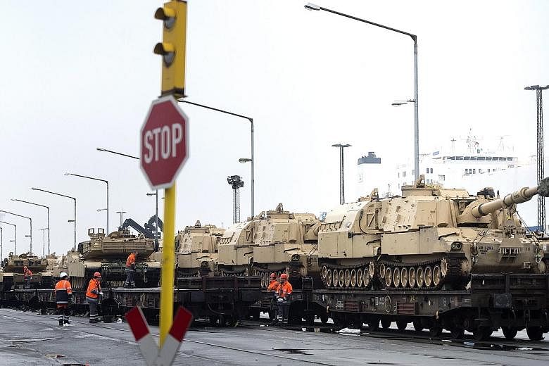 US military vehicles being prepared for railway transport in Bremerhaven, northern Germany, last Saturday. A contingent of US troops entered Poland at the Olszyna border crossing with Germany yesterday, with heavy equipment to follow.