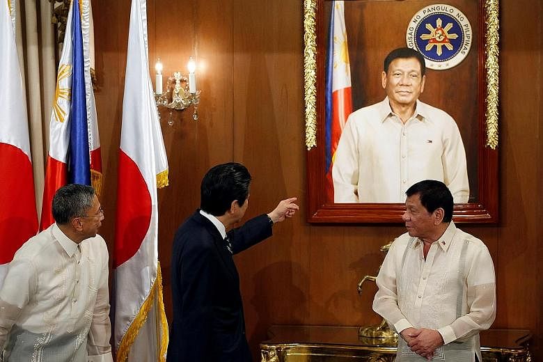 Mr Abe and Mr Duterte at the presidential palace in Manila yesterday. The Japanese Premier is keen on keeping strong ties with the Philippines as Mr Duterte shifts away from Japan's close ally, the United States.