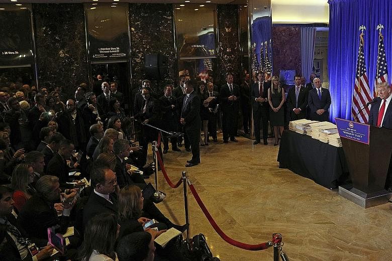 US President-elect Donald Trump holding a press conference in the lobby of Trump Tower in New York on Wednesday. With him are (from right) Vice-President-elect Mike Pence and Mr Trump's children Donald Jr, Ivanka and Eric. It was the first press conf