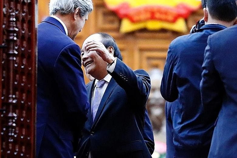 Vietnamese Prime Minister Nguyen Xuan Phuc reaching out to hug US Secretary of State John Kerry after a meeting yesterday.