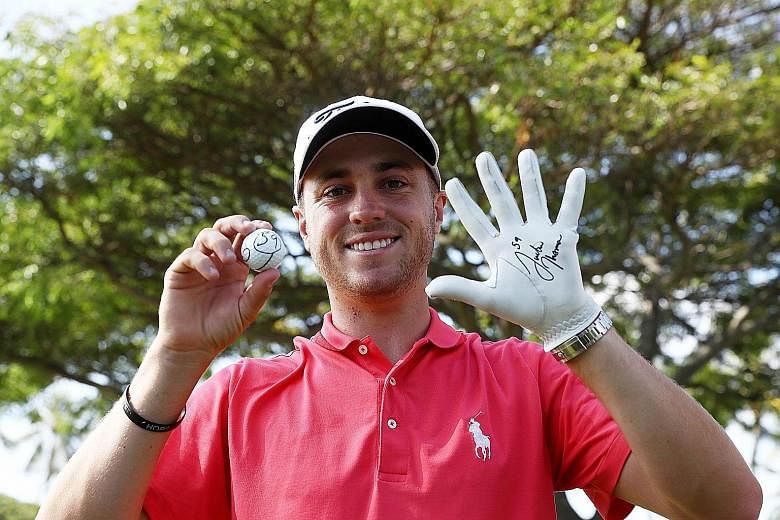 American golfer Justin Thomas celebrates after scoring a 59 during the first round of the Sony Open In Hawaii. He is the seventh player to break 60 on the PGA Tour.