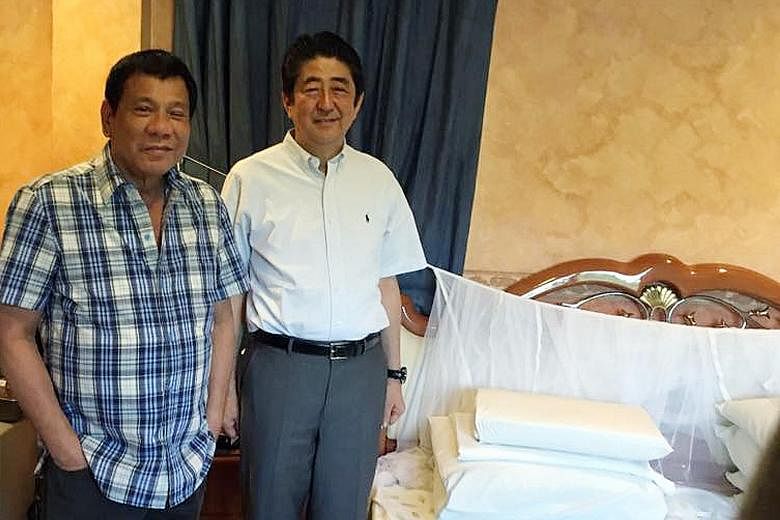 Philippine President Rodrigo Duterte giving Japanese Prime Minister Shinzo Abe a tour of his home in Davao City, including his bedroom, where he showed him his old favourite mosquito net, which he still uses. The two later had breakfast at a small ta