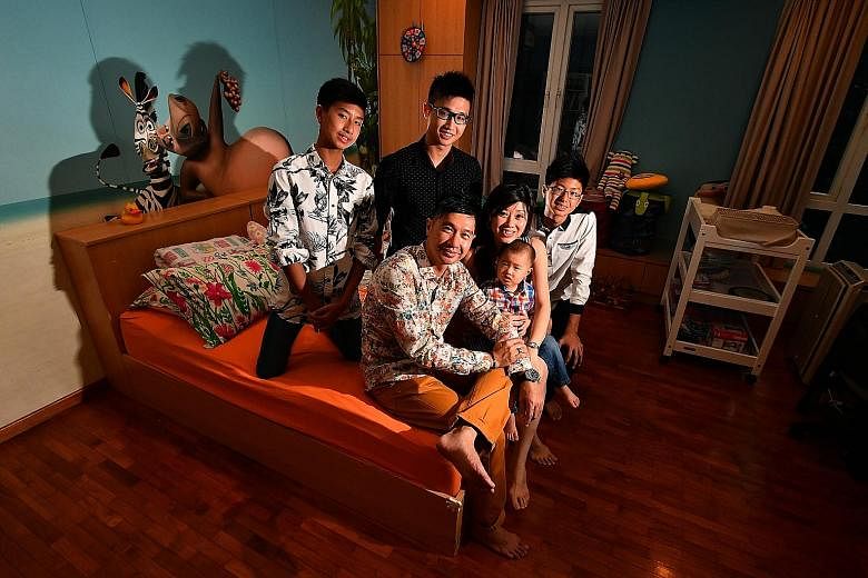 Mr Freddy Sim and his wife Viviena with their sons (clockwise from left) Euan, 14, a Secondary 2 student at ACS Barker, Eugene, 21, a Year 3 student studying computer engineering at Ngee Ann Polytechnic, Ethan, 15, a Secondary 3 student at ACS Barker