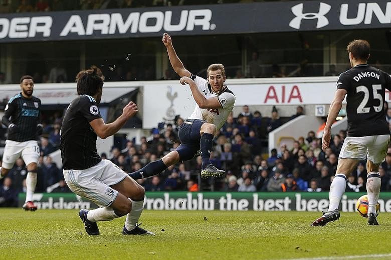 Tottenham's Harry Kane scoring his team's third goal against West Brom at White Hart Lane yesterday. He finished with a hat-trick in a 4-0 Premier League thumping of the visitors.