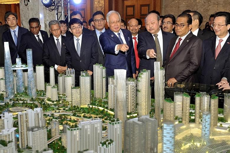 PM Najib Razak and Chinese Ambassador to Malaysia Huang Huikang (right) looking at a model of the Bandar Malaysia project last year. Former deputy PM Muhyiddin Yassin, in criticising China, has said that many Malaysians would not feel comfortable see