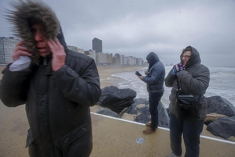 People braving the stormy weather along the seafront in Oostende, Belgium, last Friday. The same storm, officially named Egon, has also battered Germany. A refugee camp on Lesvos island in Greece. The cold snap across Europe has killed more than 60 p
