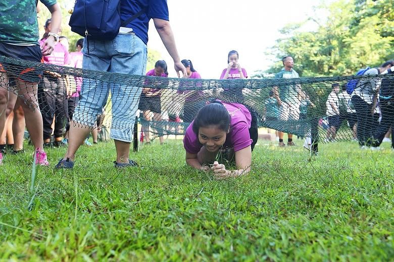At the launch of the ActiveSG Outdoor Adventure Club yesterday, participants could try out an obstacle course (above) as well as learn various skills such knot tying (left).