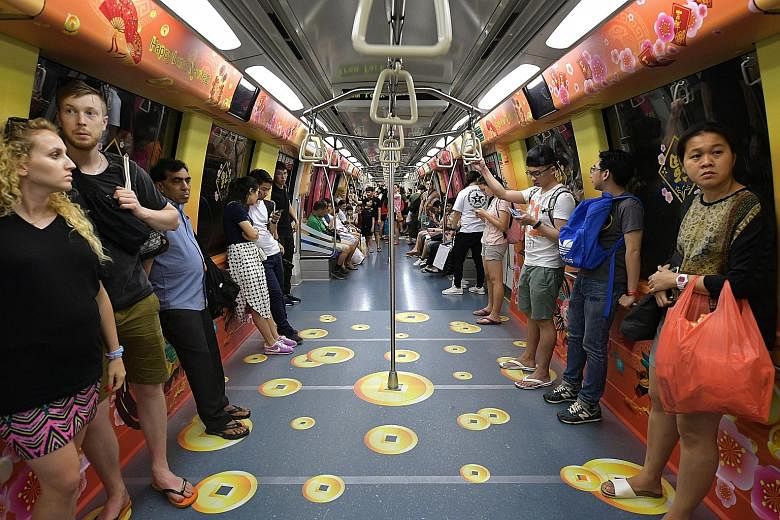 Commuters on the North-East Line may spot gold coins on the floor of a train cabin - but they aren't the real deal. To celebrate the coming Chinese New Year, the train has also been decorated with rooster, hen and chick motifs, along with traditional
