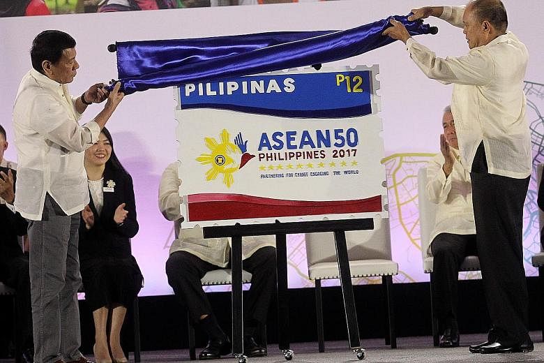 Philippine President Rodrigo Duterte (far left) and Postmaster General Joel Otarra unveiling the Asean Chairmanship Special Stamp at the SMX Convention Centre in Davao yesterday, as the country took over chairmanship of the regional grouping.