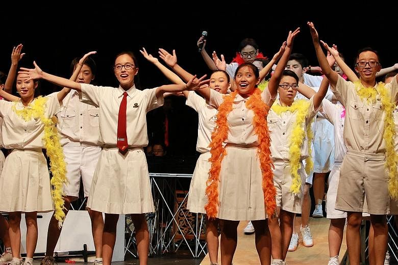Erika (far right) managed her time well by also trying to complete her homework during rehearsal breaks. The 16-year-old (with orange streamer, right) took part in a school musical in her final year.