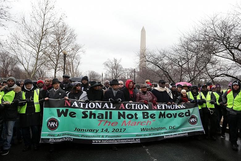 Amid a steady drizzle, thousands of demonstrators marched on Saturday from the Washington Monument to the Martin Luther King Jr Memorial in Washington, DC, seeking to bring attention to issues such as immigration, police brutality and affordable heal