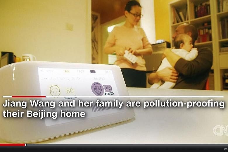 Madam Wang Jiang and her husband Ludovic Bodin have spent US$11,500 (S$16,400) on air purifiers for their home, including a device that tracks the indoor air quality.