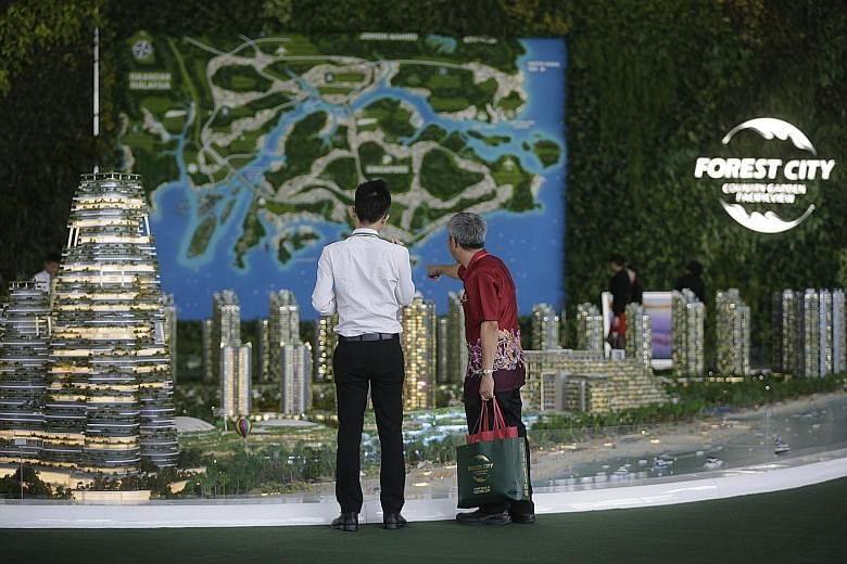A futuristic "eco-city" of high-rise homes and waterfront villas, Forest City in Johor will sit on four man-made islands on the Malaysian side of the Johor Strait. Dr Mahathir claimed that "already thousands of units have been completed and sold to m