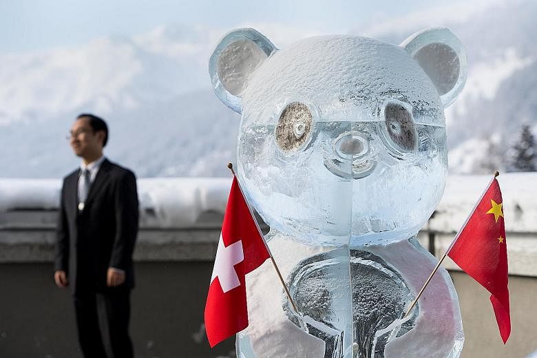 A panda ice sculpture holding the Swiss and Chinese flags, as the two countries launched a joint year of tourism on the sidelines of the World Economic Forum in Davos.