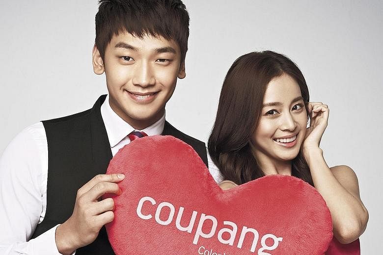 South Korean singer Rain and actress Kim Tae Hee, seen here in an advertisement, are expected to wed in a Catholic church in Seoul tomorrow.