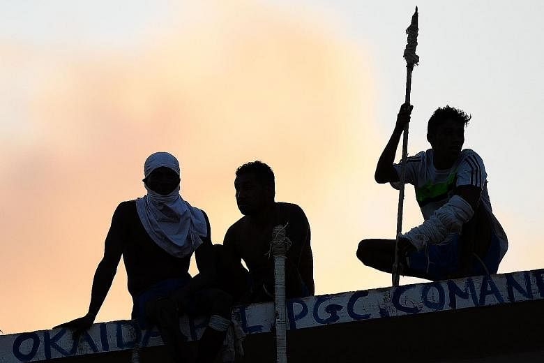 Prisoners atop the roof of a compound celebrating the transfer of their leaders after a negotiation with the police at the Alcacuz Penitentiary, in Rio Grande do Norte, on Monday. On Sunday, the police stormed the prison and ended a night-long riot. 