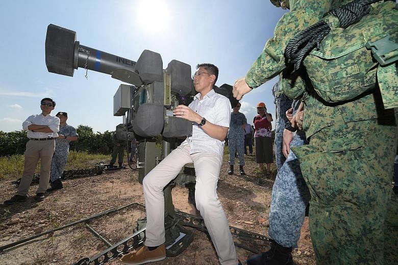 Senior Minister of State for Defence Mohamad Maliki Osman gets a feel of the RBS-70 missile system. Dr Maliki visited the Safti Live Firing Area yesterday, where RSAF's Ground-Based Air Defence units were competing against each other in the annual Fl