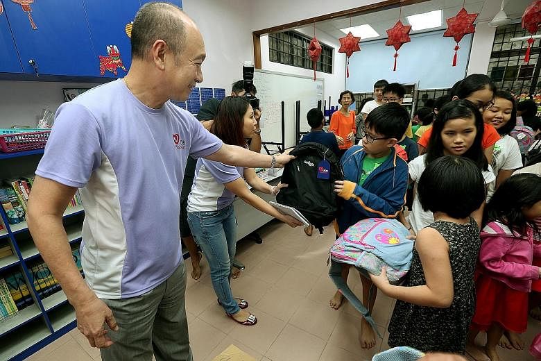 CEO Wee Ee Cheong joined other UOB senior management, staff and clients in giving out school bags to children in Bukit Batok yesterday.