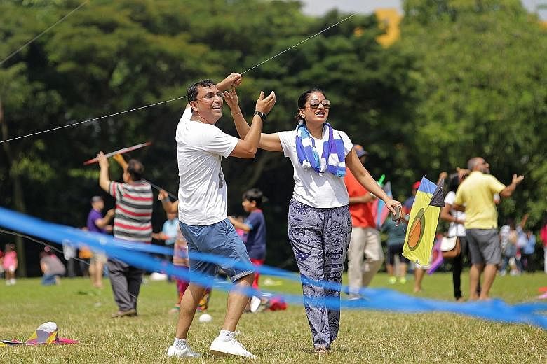 Mr Nilang Shah, 41, flying a kite with his wife Tasneem Shah, 40, at West Coast Park on Sunday, during the Singapore Gujarati Society's celebration of Utraan, the Gujarati kite-flying festival. An 1886 Straits Settlements bank note from HSBC, which f