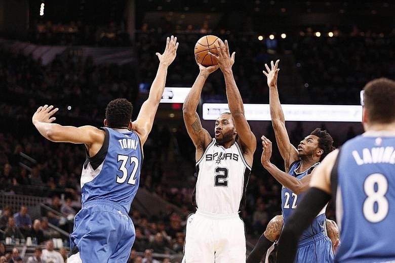 Spurs forward Kawhi Leonard shoots the ball over Minnesota Timberwolves centre Karl-Anthony Towns at the AT&T Centre. He finished with 34 points, becoming the first Spurs player to score 30-plus points in four straight games since Tim Duncan in Janua