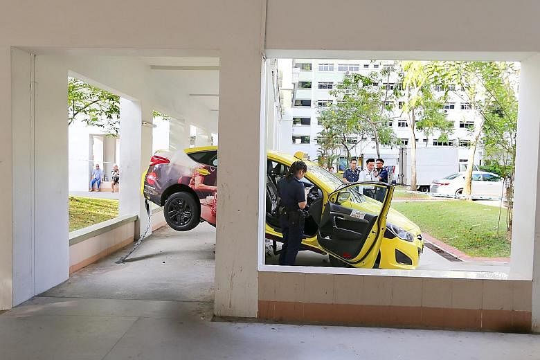 The taxi mounted a kerb and shot up a low wall before getting wedged in the middle of a sheltered walkway in Jurong West Street 81. No injuries were reported, according to the Singapore Civil Defence Force.