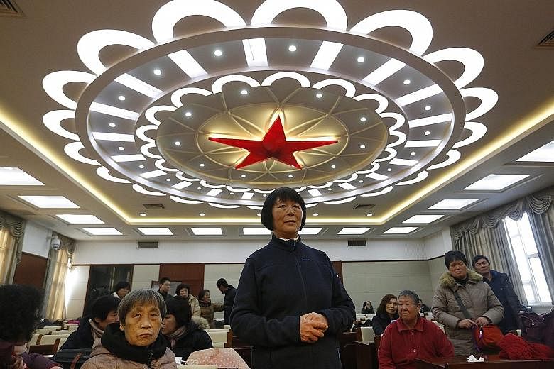 Relatives of MH370 passengers waiting to meet airline officials in Beijing on Wednesday, a day after the official search for the missing plane was suspended.