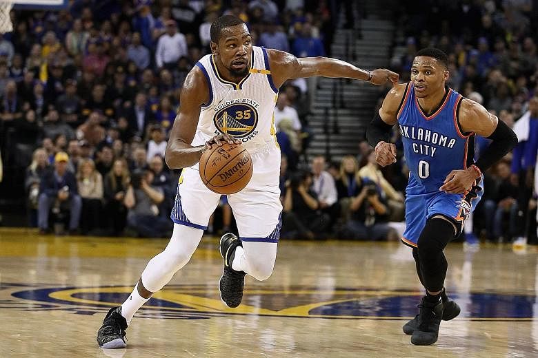 Warriors forward Kevin Durant dribbles past former team-mate and Thunder star Russell Westbrook at Oracle Arena. Durant had a season-best 40 points on Wednesday.