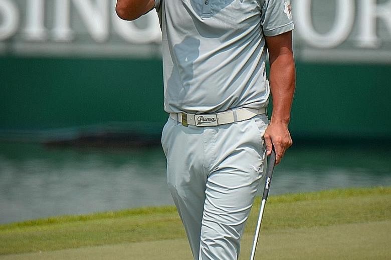 Former world No. 1 Adam Scott throws his putter in frustration at the par-four ninth hole at Sentosa's Serapong course. The Australian made par at that hole but dropped shots at the par-five seventh (triple bogey) and par-three eighth (bogey). The th