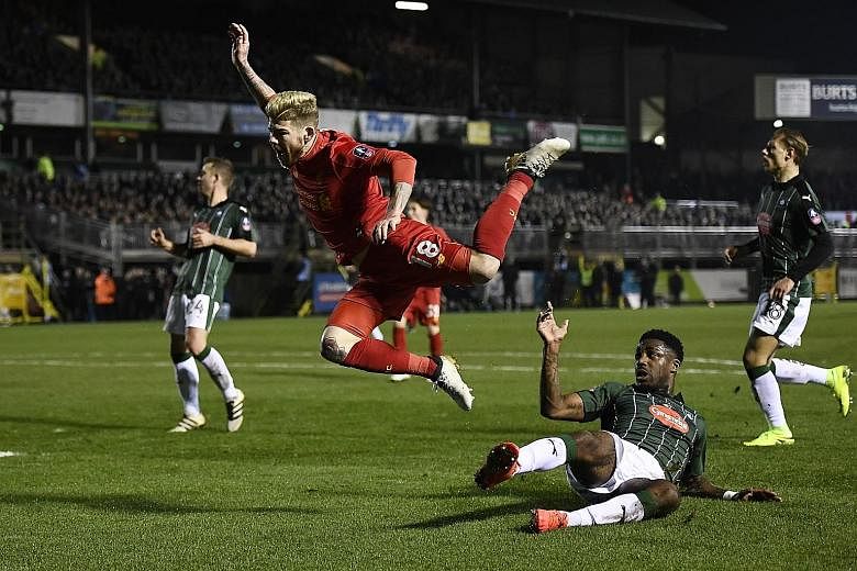 Plymouth defender Yann Songo'o fouls Liverpool's Alberto Moreno in the box. The resulting penalty, taken by forward Divock Origi, was saved by goalkeeper Luke McCormick.