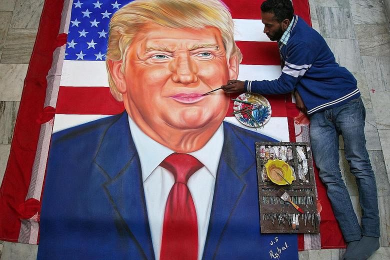 In Amritsar, India, artist Jagjot Singh Rubal readies his portrait of Mr Trump in honour of the US President-elect’s inauguration. Mr Rubal has painted portraits of several politicians, including that of British Prime Minister Theresa May.